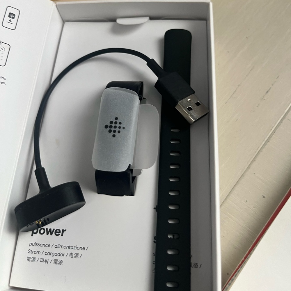 fitbit Black and Silver Fitness Tracker with Charging Cable
